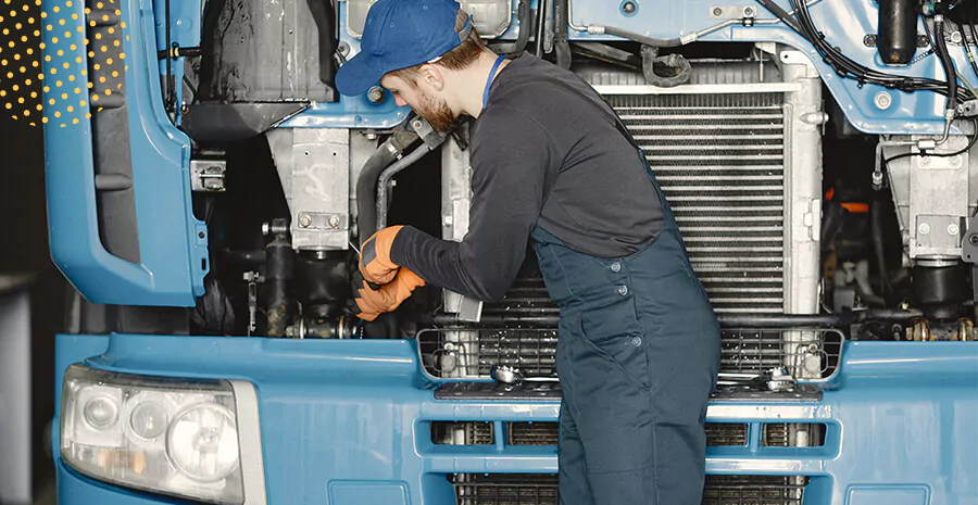 imagem de um mecânico mexendo em um caminhão