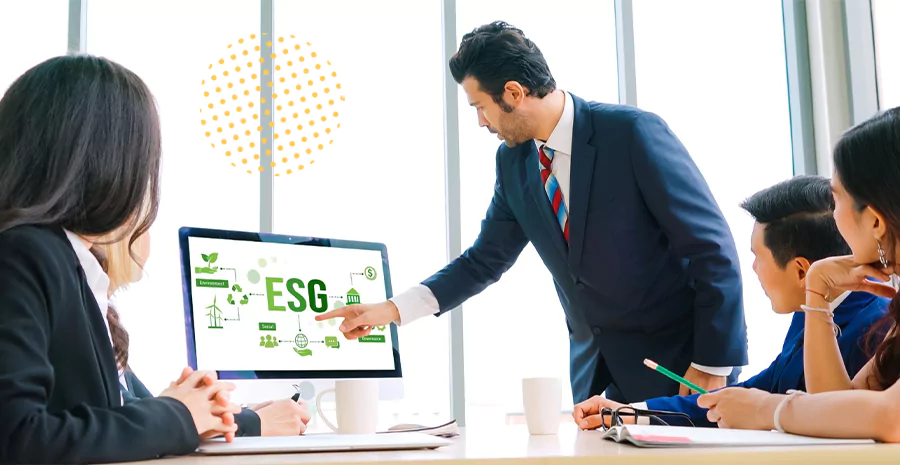 Quatro pessoas observando um monitor com o acrônimo ESG
