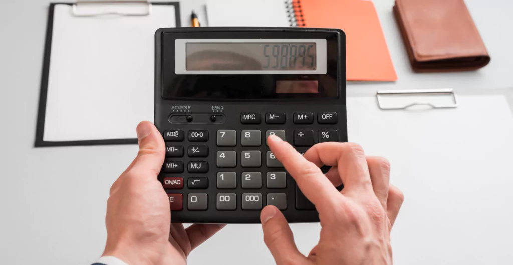 pessoa fazendo calculos em uma calculadora